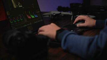 Asian creator editing production work in neon-lit office. video