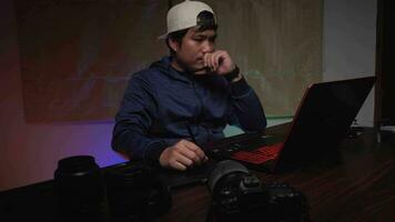 Asian creator editing production work in neon-lit office. video