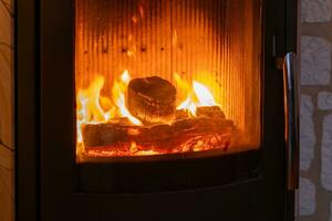 a stove with burning coals in the apartment photo