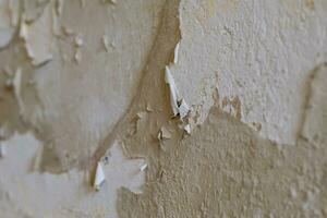 old wall with torn off wallpaper photo