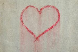 a red heart painted on a wall photo