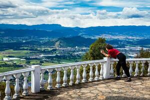 Young woman at a viewpoint over the beautiful Sopo valley at the department of Cundinamarca in Colombia photo