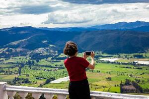 Young woman at a viewpoint over the beautiful Sopo valley at the department of Cundinamarca in Colombia photo