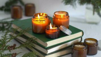 A set of different aroma candles in glass jars on a white background. Scented handmade candle. Soy candles are burning in a jar.Wax and paraffin in a jar video