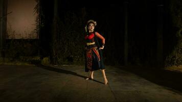 an Indonesian dancer looks full of enthusiasm and shows his courage to move and dance photo