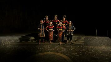 a group of dancers standing very proud and happy after finishing performing on stage photo