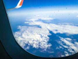 Shot of the snowflakes on the window of the airplane. photo