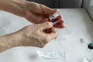 Close upshot of the woman preparing medicine for injection. Healthcare photo