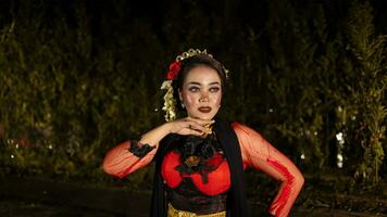 a female dancer in a red dress danced on stage, reflecting the beauty of her movements and adding to the charm of her performance photo