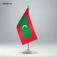 Flag of Maldives hanging on a flag stand. vector