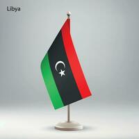 Flag of Libya hanging on a flag stand. vector