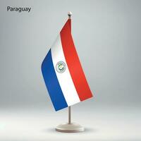 Flag of Paraguay hanging on a flag stand. vector