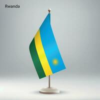 Flag of Rwanda hanging on a flag stand. vector