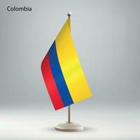 Flag of Colombia hanging on a flag stand. vector