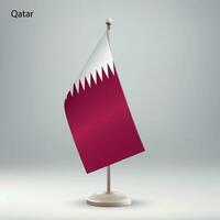 Flag of Qatar hanging on a flag stand. vector