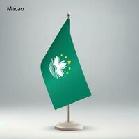 Flag of Macao hanging on a flag stand. vector