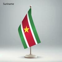 Flag of Suriname hanging on a flag stand. vector