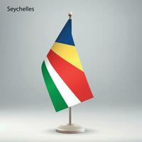 Flag of Seychelles hanging on a flag stand. vector