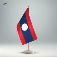 Flag of Laos hanging on a flag stand. vector