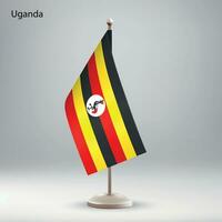 Flag of Uganda hanging on a flag stand. vector