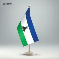 Flag of Lesotho hanging on a flag stand. vector