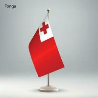 Flag of Tonga hanging on a flag stand. vector