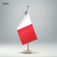 Flag of Malta hanging on a flag stand. vector