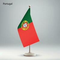 Flag of Portugal hanging on a flag stand. vector
