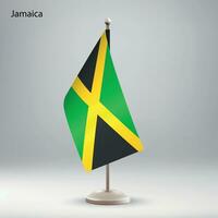 Flag of Jamaica hanging on a flag stand. vector