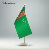 Flag of Turkmenistan hanging on a flag stand. vector