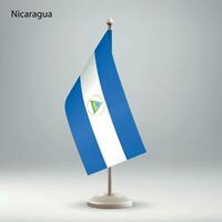 Flag of Nicaragua hanging on a flag stand. vector