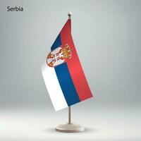 Flag of Serbia hanging on a flag stand. vector