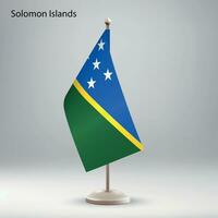 Flag of Solomon Islands hanging on a flag stand. vector