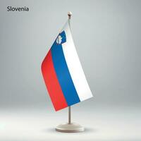 Flag of Slovenia hanging on a flag stand. vector