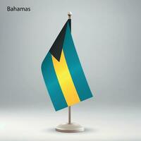 Flag of Bahamas hanging on a flag stand. vector