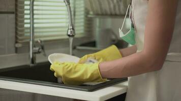 Close-up of woman's hand washing dishes at home video