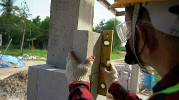 A worker is checking the balance on a house pole. video