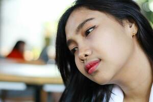 close up of relax asian woman face in indoor cafe photo