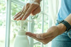 Close-up of hand washing with alcohol gel photo