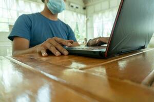 Asian men seek employment through online freelance channels. Serious Asian man observes information for planning remote work projects from laptop computers. photo