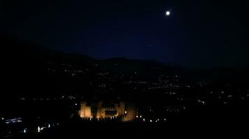 Night aerial view of Fenis castle Aosta valley Italy full moon night video