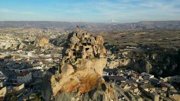 Aerial drone view of the Ortahisar Castle in Cappadocia, Turkey with the snow capped Mount Erciyes in the background. video