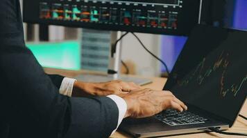 Financial Analyst Working on a Computer with Multi-Monitor Workstation with Real-Time Stocks, Commodities and Foreign Exchange Charts. Businessman Works in Investment Bank City Office at Night. video