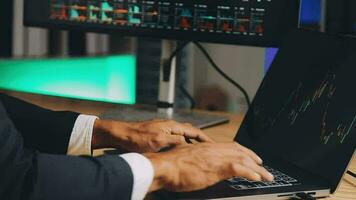 Financial Analyst Working on a Computer with Multi-Monitor Workstation with Real-Time Stocks, Commodities and Foreign Exchange Charts. Businessman Works in Investment Bank City Office at Night. video