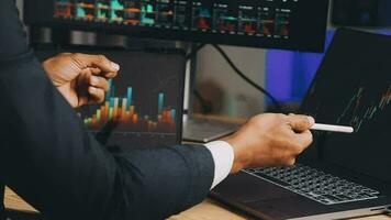 Financial Analyst Working on a Computer with Multi-Monitor Workstation with Real-Time Stocks, Commodities and Foreign Exchange Charts. Businessman Works in Investment Bank City Office at Night. video