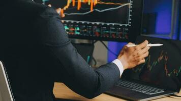 Financial Analyst Working on a Computer with Multi-Monitor Workstation with Real-Time Stocks, Commodities and Foreign Exchange Charts. Businessman Works in Investment Bank City Office at Night. video