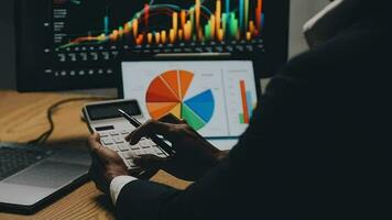 Financial Analyst Working on a Computer with Multi-Monitor Workstation with Real-Time Stocks, Commodities and Foreign Exchange Charts. Businessman Works in Investment Bank City Office at Night. video