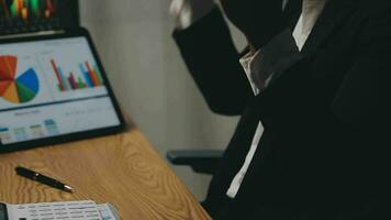 Financial Analyst Working on a Computer with Multi-Monitor Workstation with Real-Time Stocks, Commodities and Foreign Exchange Charts. Businessman Works in Investment Bank City Office at Night. video