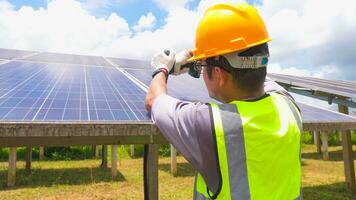Two asian engineers installing solar panels . Solar energy clean and green alternative energy. Unity and teamwork. photo