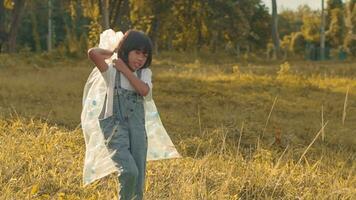 Kid Girl  collection plastic garbage in nature. kid picking up trash in park. photo